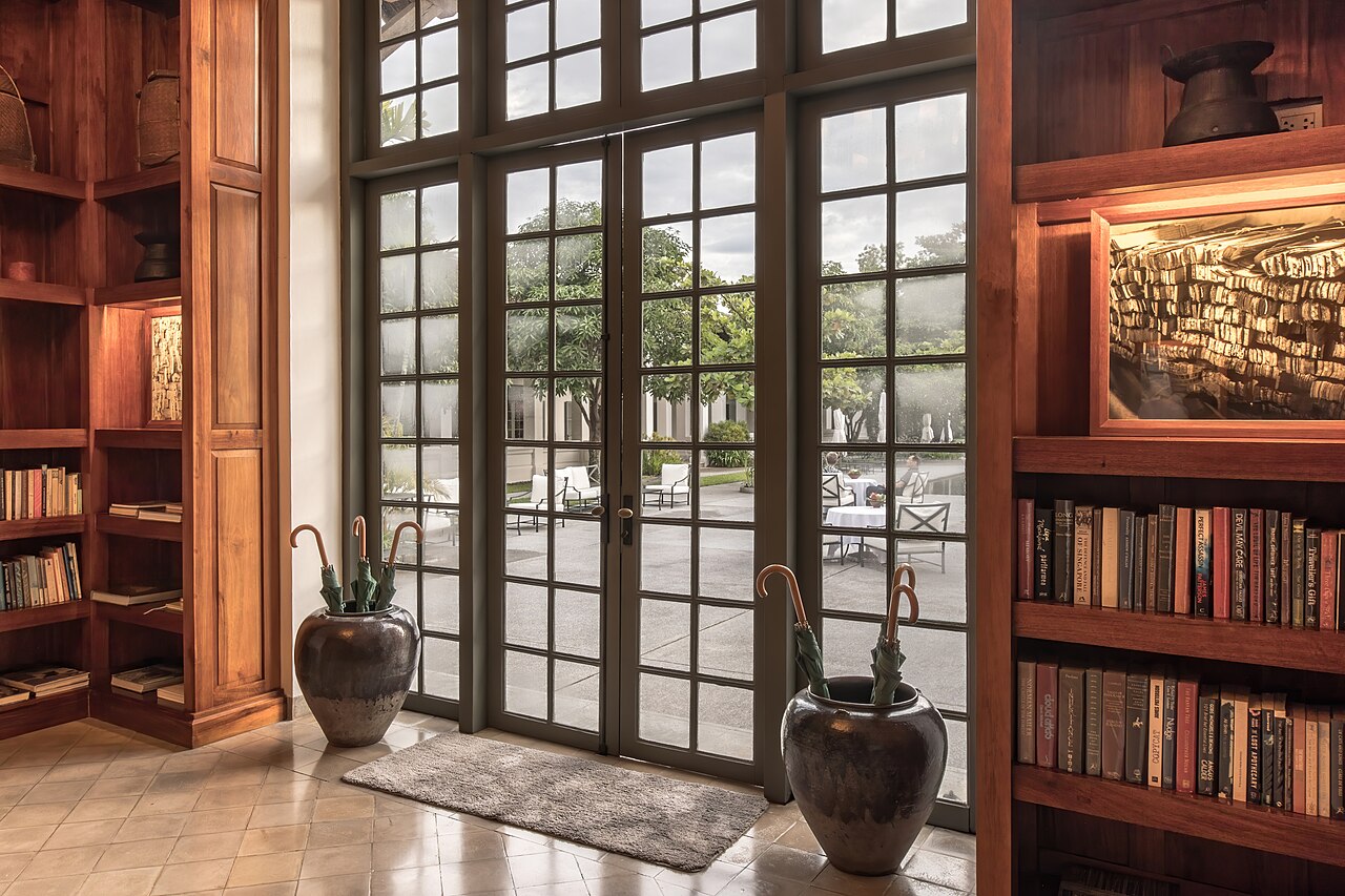 Glazed doors between wooden shelves with plants in clay pots